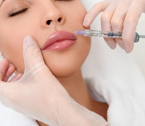 Professional cosmetologist making facial injection
